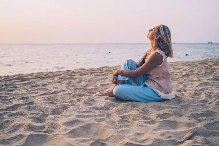 vrouw-op-strand-zittend